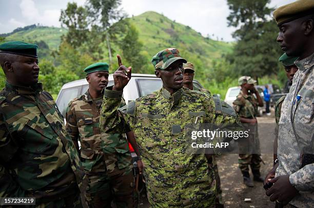 The military chief of the M23 rebels Brigadier-General Sultani Makenga addresses officers whilst visiting withdrawing troops near to the town of...