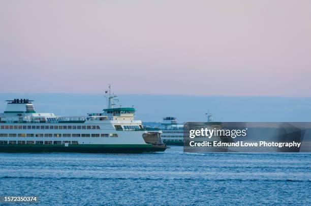 ferry boats cross paths on the way to seattle and bainbridge island, washington. - seattle ferry stock pictures, royalty-free photos & images