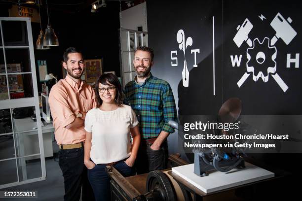 Joe Ross, left to right, Jennifer Blanco and John Earles pose for a photo at the front of their graphic design and printing business Spindletop...