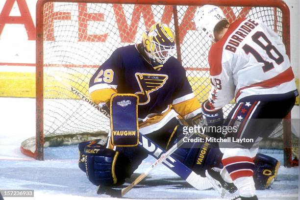 Jim Hrivnak of the St. Louis Blues makes a save on a shot by Randy Burridge of the Washington Capitals during a hockey game on November 24, 1993 at...