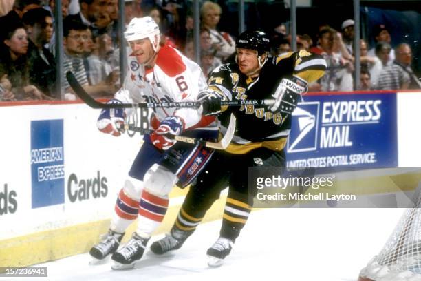 Doug Brown of the Pittsburgh Penguins fights for position with Calle Johansson of the Washington Capitals during a hockey game on January 26, 1993 at...