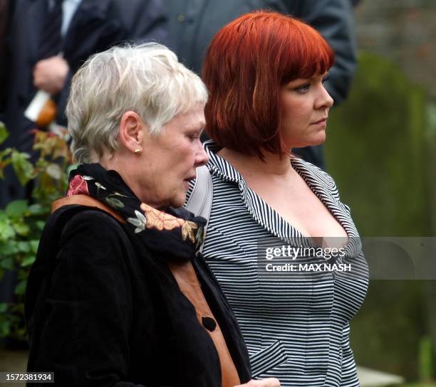 British actress Dame Judi Dench accompanied by her daughter Vinty, leaves the church of St. Mary The Virgin in Denham after attending the funeral of...