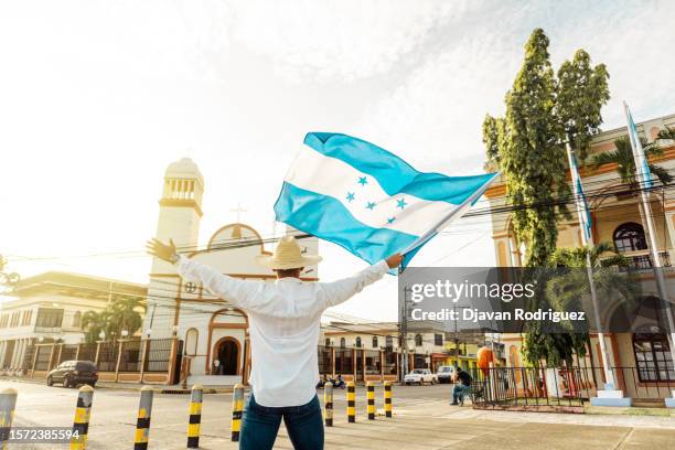 man with hat holding a honduras flag. independence concept. - honduras stock pictures, royalty-free photos & images