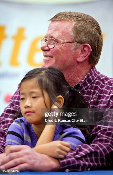 Mark Hill, sitting behind his daughter Jaiden, smiles during the news conference, Friday, November 30 at North Platte High School in Dearborn,...