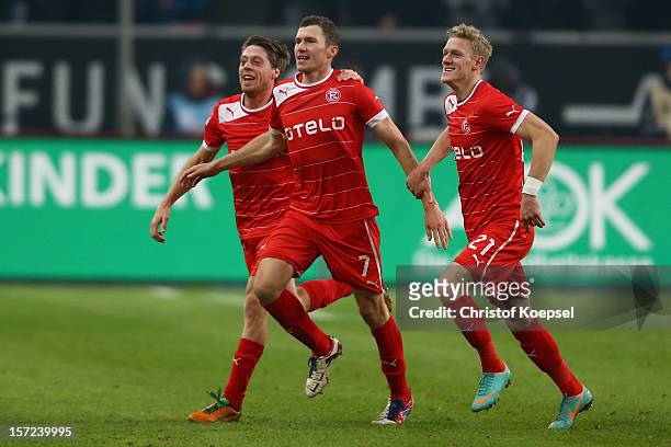 Oliver Fink of Duesseldorf celebrates the second goal with Andreas Lambertz and Johannes van den Bergh of Duesseldorf during the Bundesliga match...