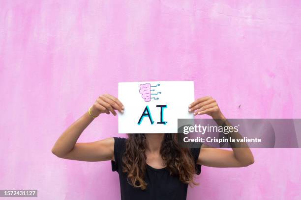 woman holding artificial intelligence sign - aprendizaje profundo fotografías e imágenes de stock