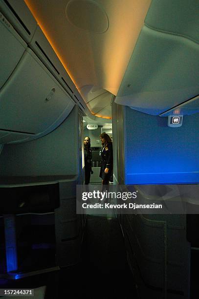 United Airlines flight attendants look at the LED cabin lighting as it changes colors on the United Airlines Boeing 787 Dreamliner at Los Angeles...