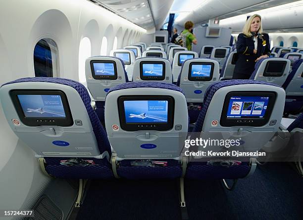 United Airlines flight attendant Tina looks at personal entertainment systems on the new Boeing 787 Dreamliner during a tour of the jet at Los...