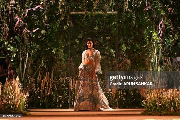 Indian Bollywood actor Shraddha Kapoor presents a creation by designer Rahul Mishra during the last day of FDCI India Couture fashion week in New...