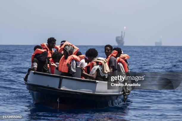 Migrants from Eritrea and 4 from Ethiopia including women and children are being rescued from a fiberglass boat in distress by the Spanish NGO Open...