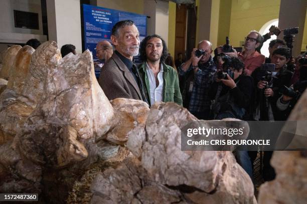 Peruvian palaeontologist Mario Urbina and scientific author Rodolfo Salas pose next to the fossilized remains of the Perucetus colossus, a primitive...