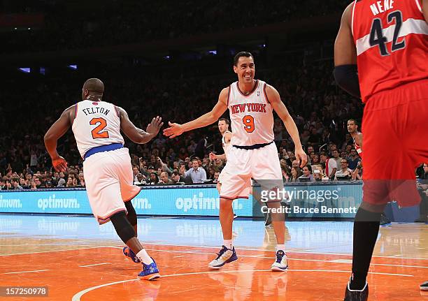 Raymond Felton slaps hands with Pablo Prigioni of the New York Knicks after his pass to J.R. Smith that he dunked against the Washington Wizards at...
