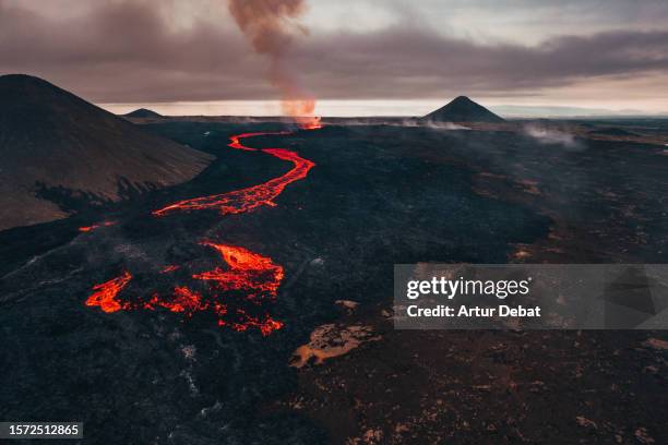 aerial view by drone of the dramatic new volcanic eruption in iceland with lava flowing. litli-hrutur 2023. - volcanic terrain stock pictures, royalty-free photos & images