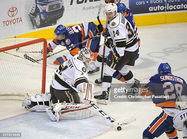 Braden Holtby of the Hershey Bears makes a save during an American Hockey League game against the Bridgeport Sound Tigers on November 30, 2012 at the...