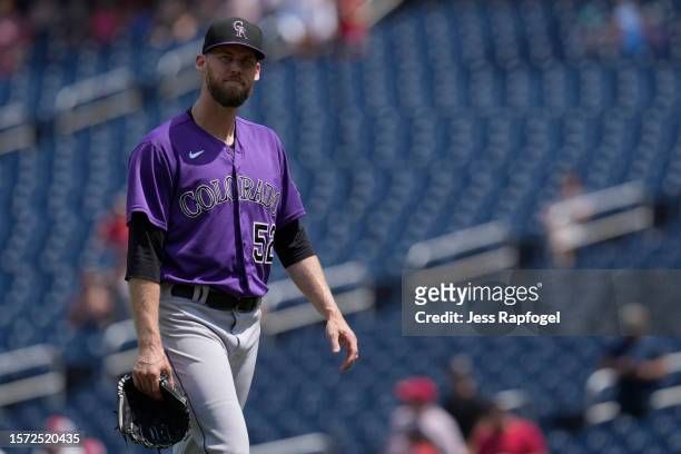 Daniel Bard of the Colorado Rockies walks to the dugout after being taken out of the game against the Washington Nationals during the ninth inning at...