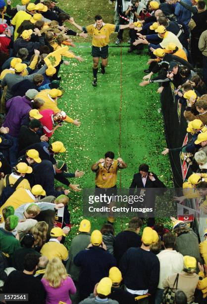 Captain John Eales and Daniel Herbert of Australia celebrate with fans during the Second Test Match between the Australian Wallabies and the British...