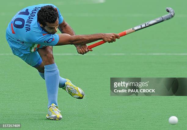 Dharamvir Singh of India strikes the ball during the pool B match between India and England at the Mens Hockey Champioships Trophy in Melbourne on...