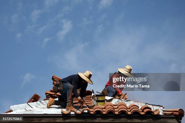 People work on the bell tower of a church amid the city's worst heat wave on record on July 26, 2023 in Phoenix, Arizona. While Phoenix endures...