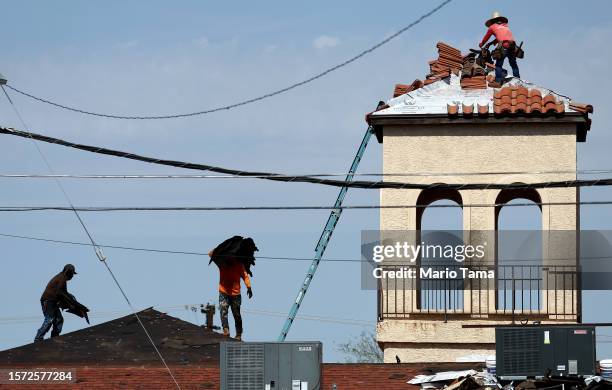 People work on the bell tower and roof of a church amid the city's worst heat wave on record on July 26, 2023 in Phoenix, Arizona. While Phoenix...