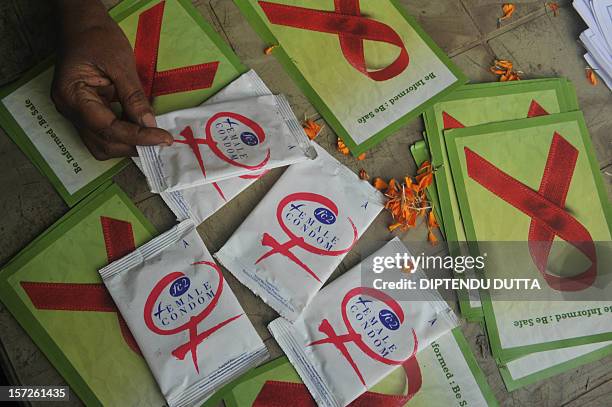 Indian volunteers and the members of the West Bengal Voluntary Health Association distribute condoms on World Aids day in Siliguri on December...