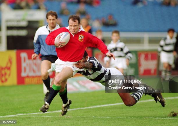 Ieuan Evans of Lions rounds Eroni Clarke of Auckland to score during the British Lions v Auckland match as part of the British Lions tour of New...