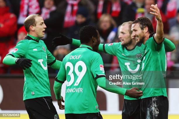 Christian Schulz of Hannover celebrates his team's first goal with team mates Konstantin Rausch, Mame Biram Diouf and Jan Schlaudraff during the...
