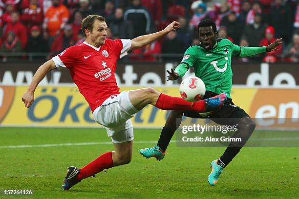 Bo Svensson of Mainz clears a cross ahead of Mame Biram Diouf of Hannover during the Bundesliga match between 1. FSV Mainz 05 and Hannover 96 at...