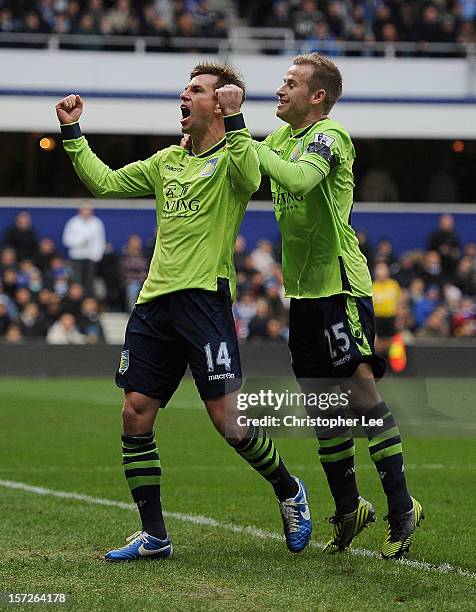 Brett Holman of Aston Villa celebrates scoring the opening goal with team mate Barry Bannan during the Barclays Premier League match between Queens...