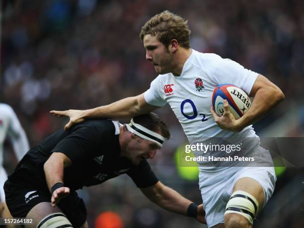 Kieran Read of New Zealand tackles Joe Launchbury of England during the QBE International match between England and New Zealand at Twickenham Stadium...