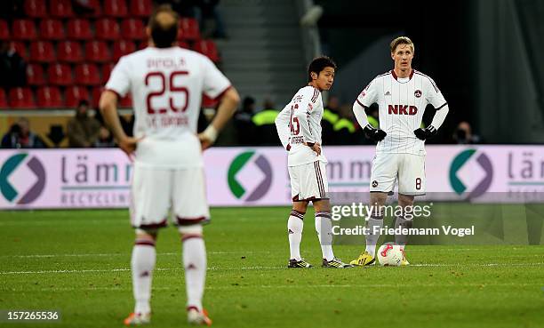 Javier Pinola, Hiroshi Kiyotake and Sebastian Polter of Nuernberg look disappointed during the Bundesliga match between Bayer 04 Leverkusen and 1. FC...