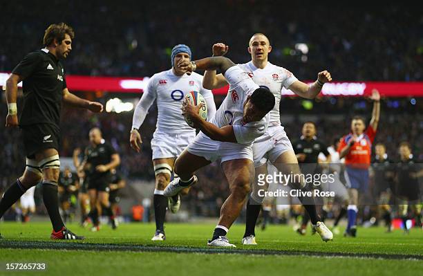 Manu Tuilagi of England goes over to score a try during the QBE International match between England and New Zealand at Twickenham Stadium on December...