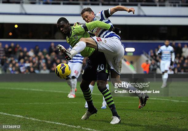 Christian Benteke of Aston Villa and Clint Hill of Queens Park Rangers battle for the ball during the Barclays Premier League match between Queens...