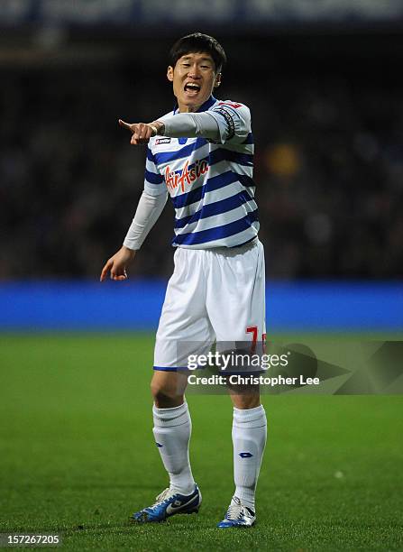 Ji-Sung Park of Queens Park Rangers directs his team during the Barclays Premier League match between Queens Park Rangers and Aston Villa at Loftus...