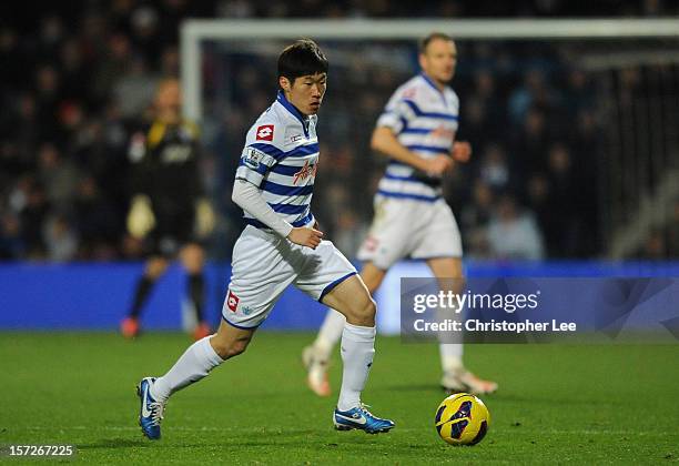 Ji-Sung Park of Queens Park Rangers runs with the ball during the Barclays Premier League match between Queens Park Rangers and Aston Villa at Loftus...