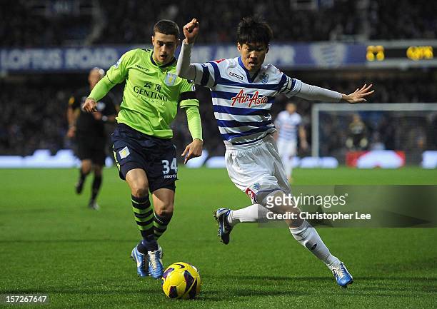Ji-Sung Park of Queens Park Rangers is closed down by Matthew Lowton of Aston Villa during the Barclays Premier League match between Queens Park...