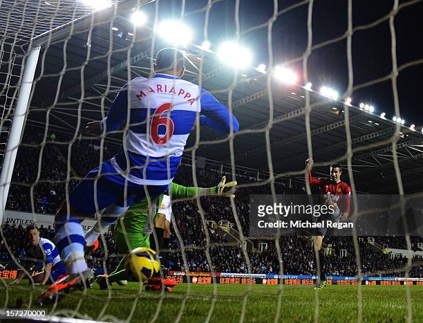 Robin van Persie of Manchester United sees his shot cross the line despite being cleared by Adrian Mariappa of Reading during the Barclays Premier...