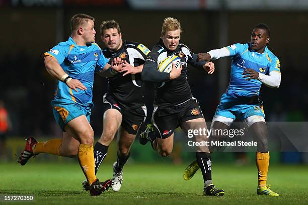 Jason Shoemark of Exeter Chiefs cuts between Phil Swainston and Christian Wade of London Wasps during the Aviva Premiership match between Exeter...