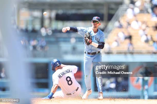 Cavan Biggio of the Toronto Blue Jays tags out Enrique Hernández of the Los Angeles Dodgers and throws to first for a double play during the fourth...