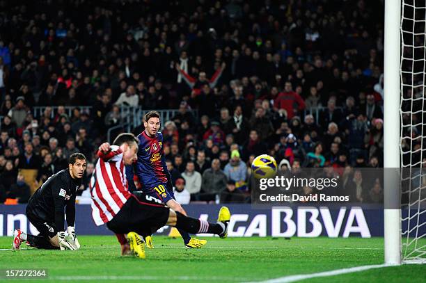 Lionel Messi of FC Barcelona scores his team's second goal past Gorka Iraizoz of Athletic Club during the La Liga match between FC Barcelona and...