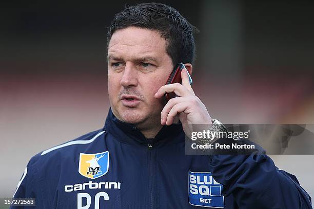 Mansfield Town manager Paul Cox talks on his mobile phone prior to the FA Cup with Budweiser Second Round match at Sincil Bank Stadium on December 1,...