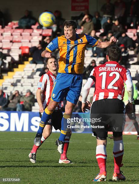 John Dempster of Mansfield Town heads the ball during the FA Cup with Budweiser Second Round match at Sincil Bank Stadium on December 1, 2012 in...