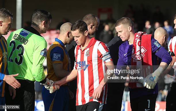 Garry Mills of Lincoln City shakes hands with Shane Redmond of Mansfield Town prior to the FA Cup with Budweiser Second Round match at Sincil Bank...