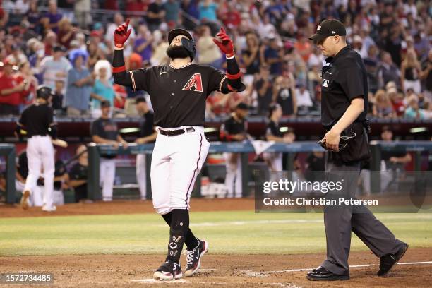 Emmanuel Rivera of the Arizona Diamondbacks reacts after hitting a solo home run against the St. Louis Cardinals during the sixth inning of the MLB...