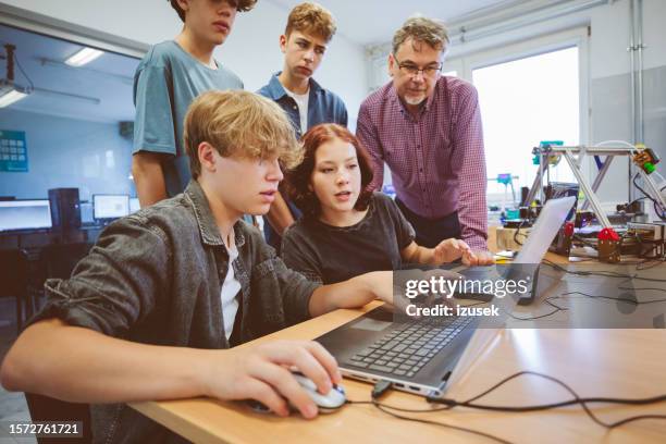 high school student and male teacher learing programming. - tech demonstration stock pictures, royalty-free photos & images