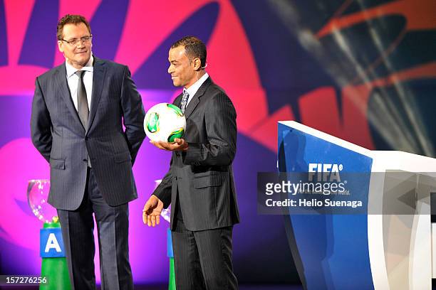 Cafu presents the official match ball and Jérôme Valcke during the Draw for the FIFA Confederations Cup at Anhembi Convention Center on December 01,...