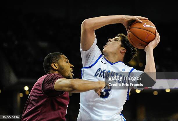 Doug McDermott of the Creighton Bluejays drives to the hoop over C.J. Aiken of the Saint Joseph's Hawks during their game at CenturyLink Center on...