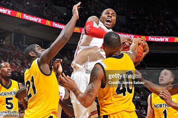 Deshaun Thomas of the Ohio State Buckeyes fights through the defense of Jalen Billups and Eshaunte Jones of the Northern Kentucky Norse to attempt a...