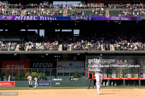 Cron of the Colorado Rockies rounds third base after hitting a go-ahead grand slam home run during the eighth inning of a game against the New York...