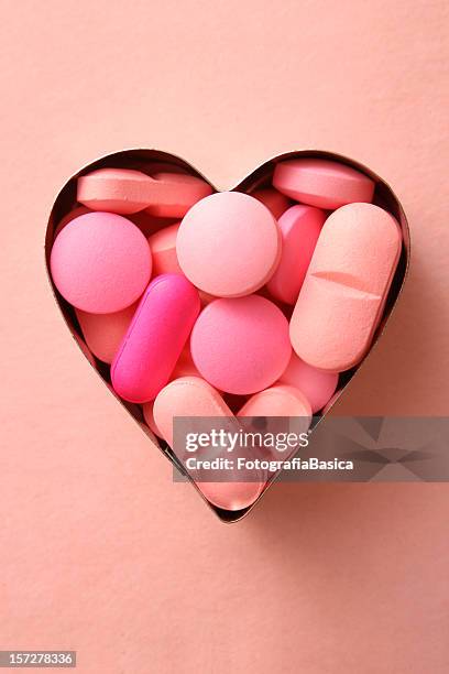 pink liebevolle details - heart pill stock-fotos und bilder