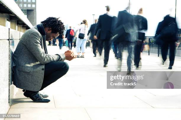 worlds apart, a man begging the busy streets of london - humility stockfoto's en -beelden